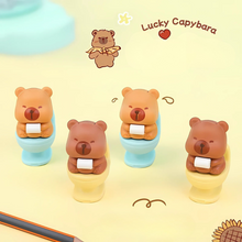 Load image into Gallery viewer, Four Capybara Eraser on Toilet Seat with 'Lucky Capybara' branding - Tinyminymo
