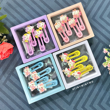 Load image into Gallery viewer, Colorful Cute Kitty Hair Clips in Clear Plastic Cases Placed on a Patterned Surface - Tinyminymo