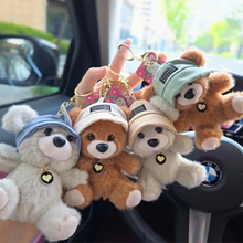 Load image into Gallery viewer, Four Cute Teddy Plush Keychain with different hats held in front of a car interior - Tinyminymo