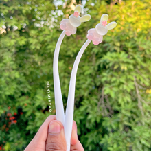 Load image into Gallery viewer, Two Dancing Bunny Gel Pens with Bunny Designs Held Against a Green Leafy Background – Tinyminymo
