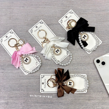 Load image into Gallery viewer, Black, Pink, White and Brown Bow Mobile Charm on a Wooden Surface - Tinyminymo
