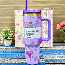 Load image into Gallery viewer, Purple Floral Stanley Cup with Purple Handle on a Blue Textured Surface - Tinyminymo