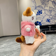 Load image into Gallery viewer, Kitty in Hoodie Plush Keychain Standing on a Person’s Hand from a Side Angle, wearing a Pink Hoodie - Tinyminymo