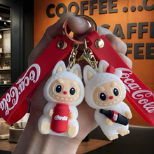 Load image into Gallery viewer, Labubu Keychain Holding Coca Cola Products in Front of a Coffee Shop - Tnyminymo