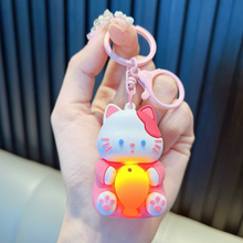 Load image into Gallery viewer, A Hand Holding a Pink Lightup Cat Keychain with a Yellow Fish - Tinyminymo