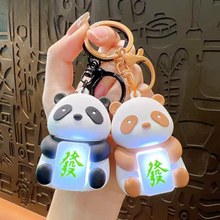 Load image into Gallery viewer, Two Lightup Panda Keychain with LED Light Box Held by a Hand - Tinyminymo