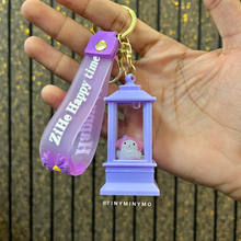 Load image into Gallery viewer, Lightup Sanrio Keychain with a Small My Melody Figure Held in a Hand Against a Wooden Background - Tinyminymo