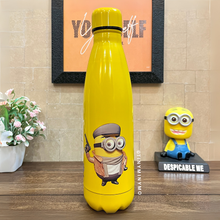 Load image into Gallery viewer, Yellow Metallic Bottle Featuring a Minion Character Placed on a Wooden Surface with a Decorative Background – Tinyminymo