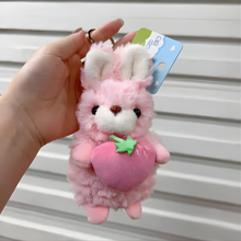 Load image into Gallery viewer, Pink Plush Bunny Keychain Holding a Strawberry Held by a Hand - Tinyminymo
