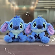 Load image into Gallery viewer, Two Blue Plush Stitch 3D Keychains with a Heart Doodle Above Them on a Blurred Background - Tinyminymo