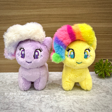 Load image into Gallery viewer, Two Plush Unicorn Charm, One Purple and One Yellow on a Textured Surface - Tinyminymo