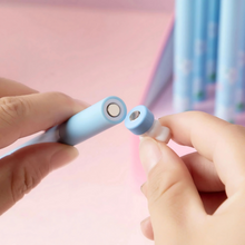 Load image into Gallery viewer, Two hands holding a Sakura Gel Pen with a Pink background - Tinyminymo