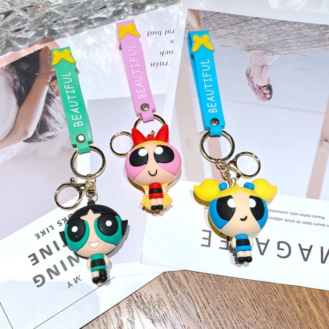 Three 3D Powerpuff Girls Keychain on a Magazine Background - Tinyminymo