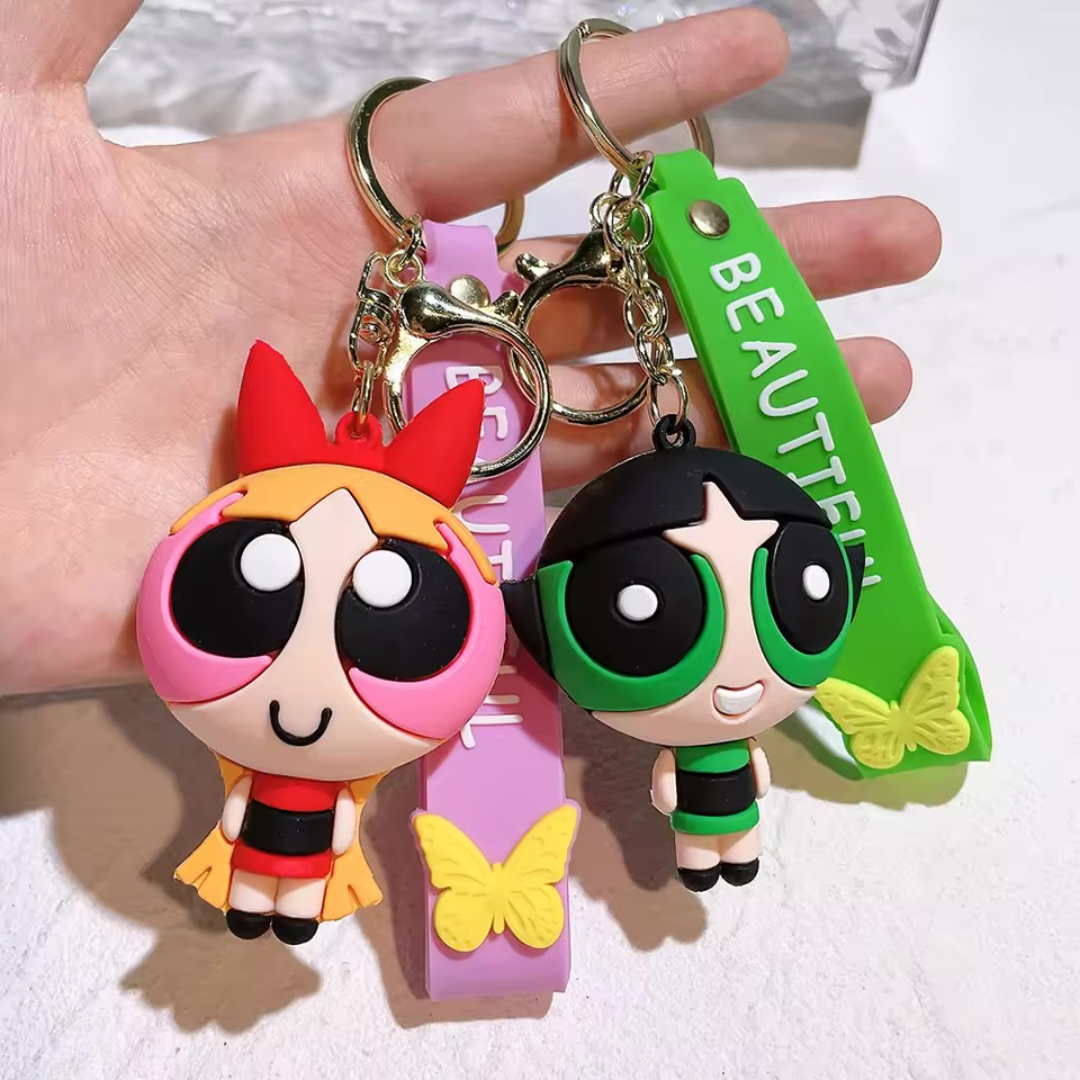 Two 3D Powerpuff Girls Keychain Held by a Hand on a White Background - Tinyminymo