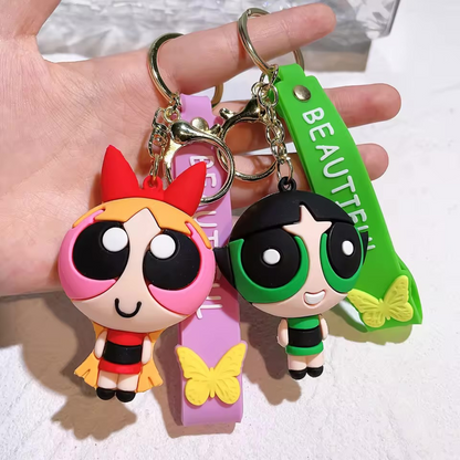 Two 3D Powerpuff Girls Keychain Held by a Hand on a White Background - Tinyminymo