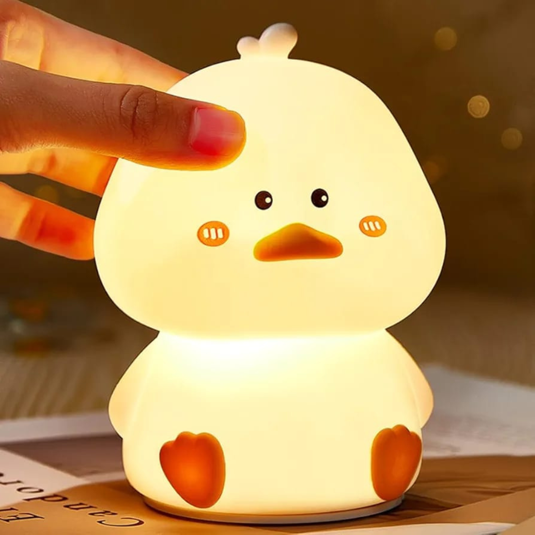 Adorable Duck Silicone Night Light,  Lightning in Bright Color being held by a  Hand - Tinyminymo