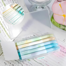 Load image into Gallery viewer, Set of Colorful Aesthetic Highlighters in Green hue in a Clear Case Placed on a Desk with a Notebook and Flower Decoration - Tinyminymo
