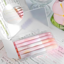 Load image into Gallery viewer, A Set of Colorful Aesthetic Highlighters in Pink Hue in a Clear Case Placed on a Surface with Writing - Tinyminymo
