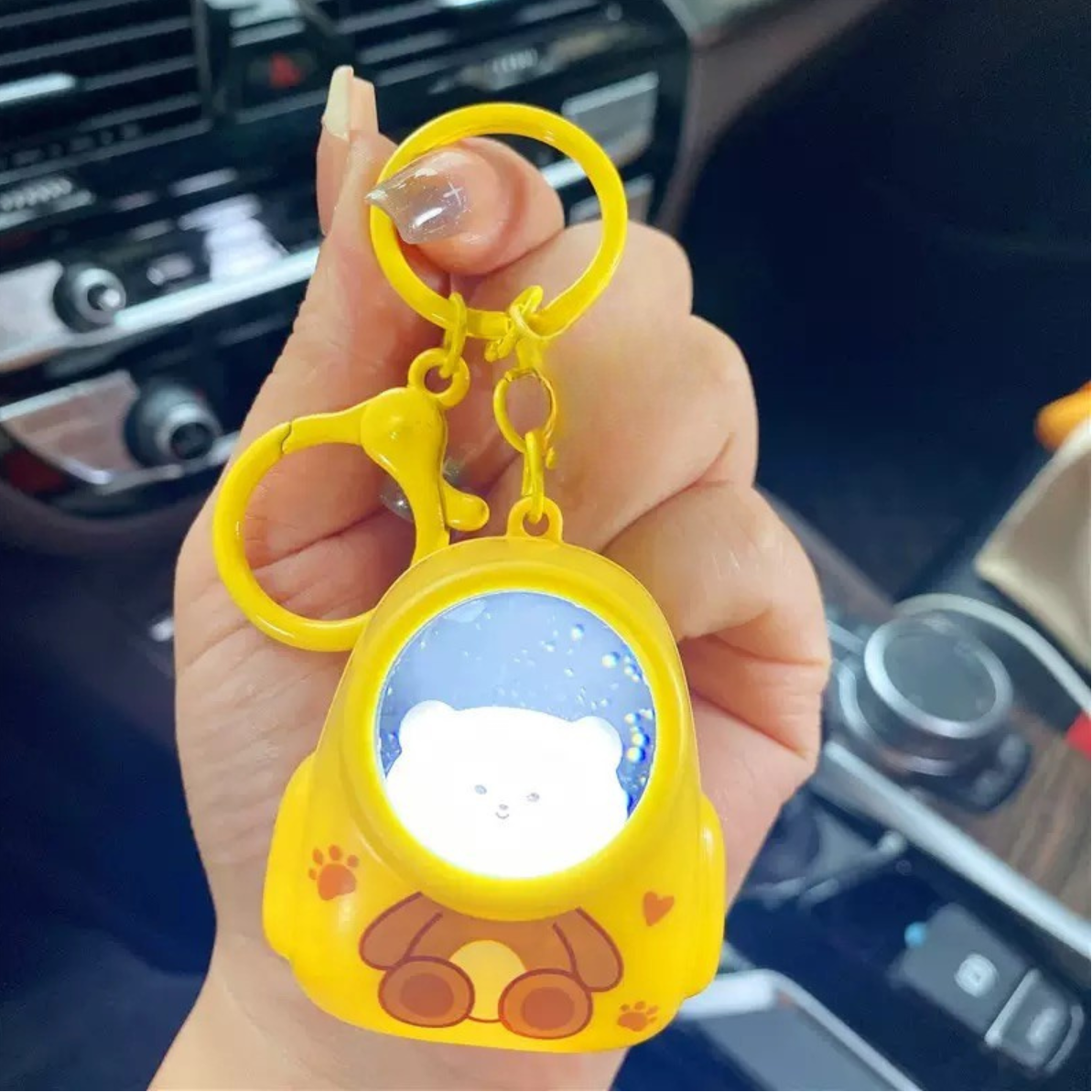 Yellow Color Astronaut Lightup Keychain Held by a Hand - Tinyminymo