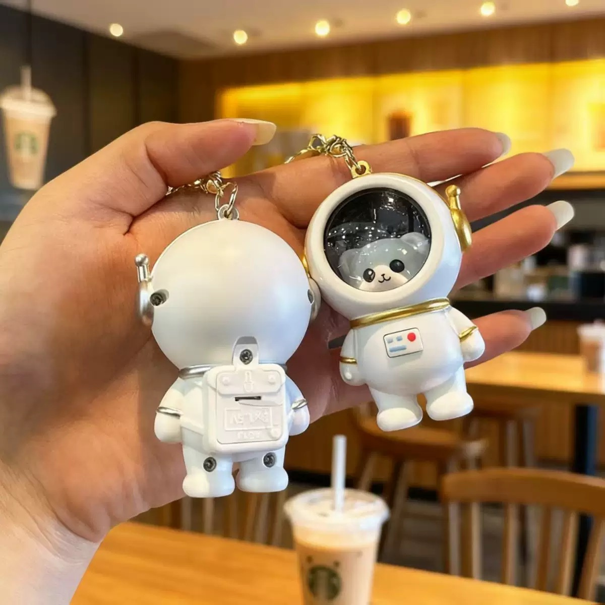 Two White Astro Animal Lightup Keychain Held by a Hand - Tinyminymo