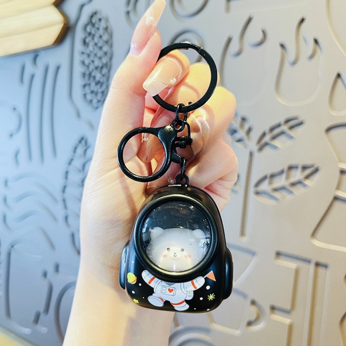Black Astro Animal Keychain Held by a Hand - Tinyminymo