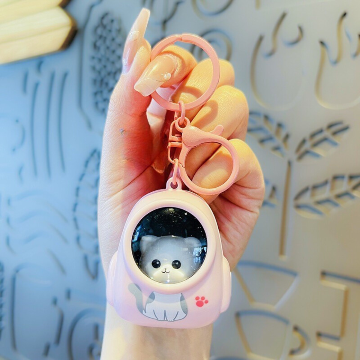 Hand Holding a Cute Lightup Keychain with Cat Design - Tinyminymo