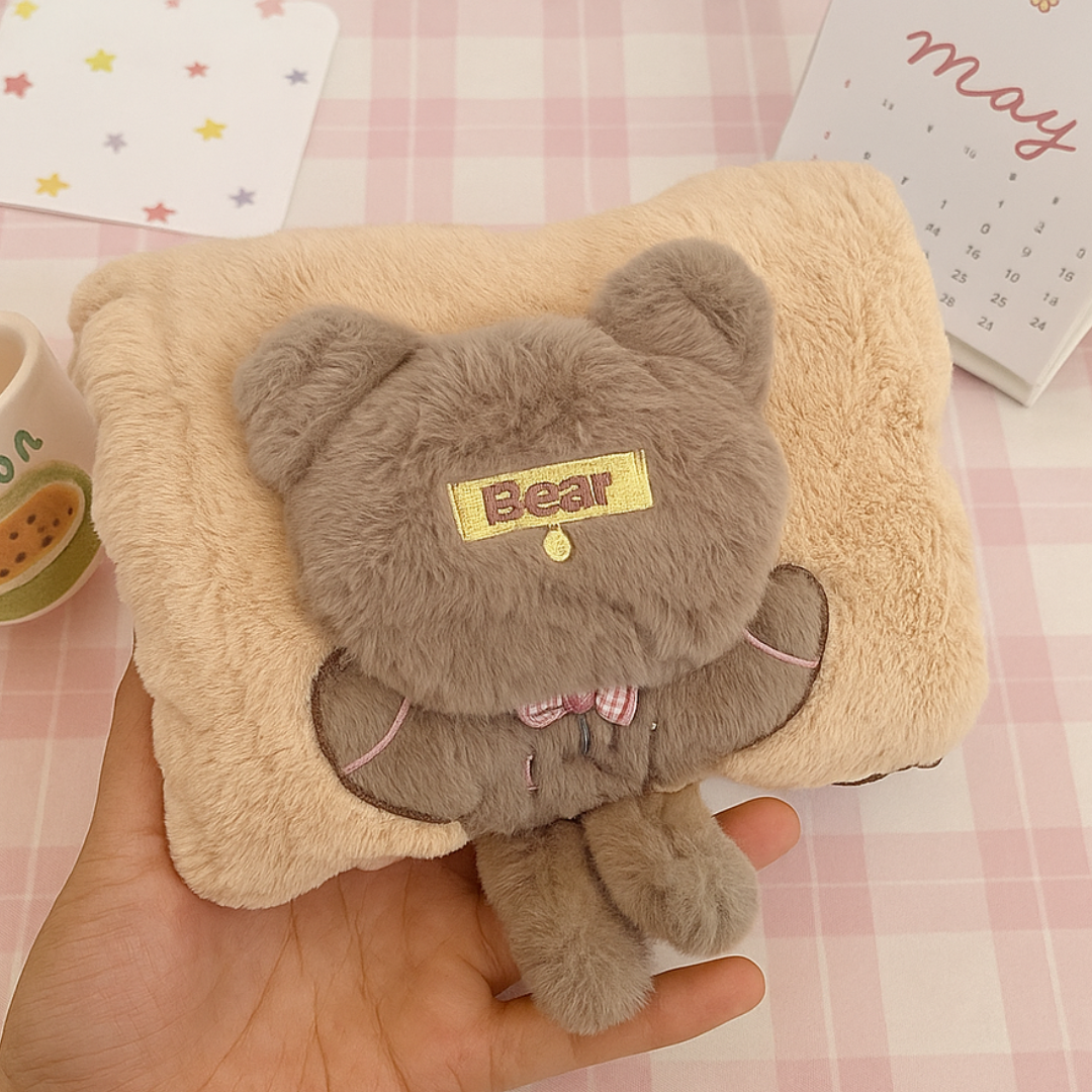 Beige Bear Electric Furr Hot Water Bag held in a Hand on a Light Surface - Tinyminymo