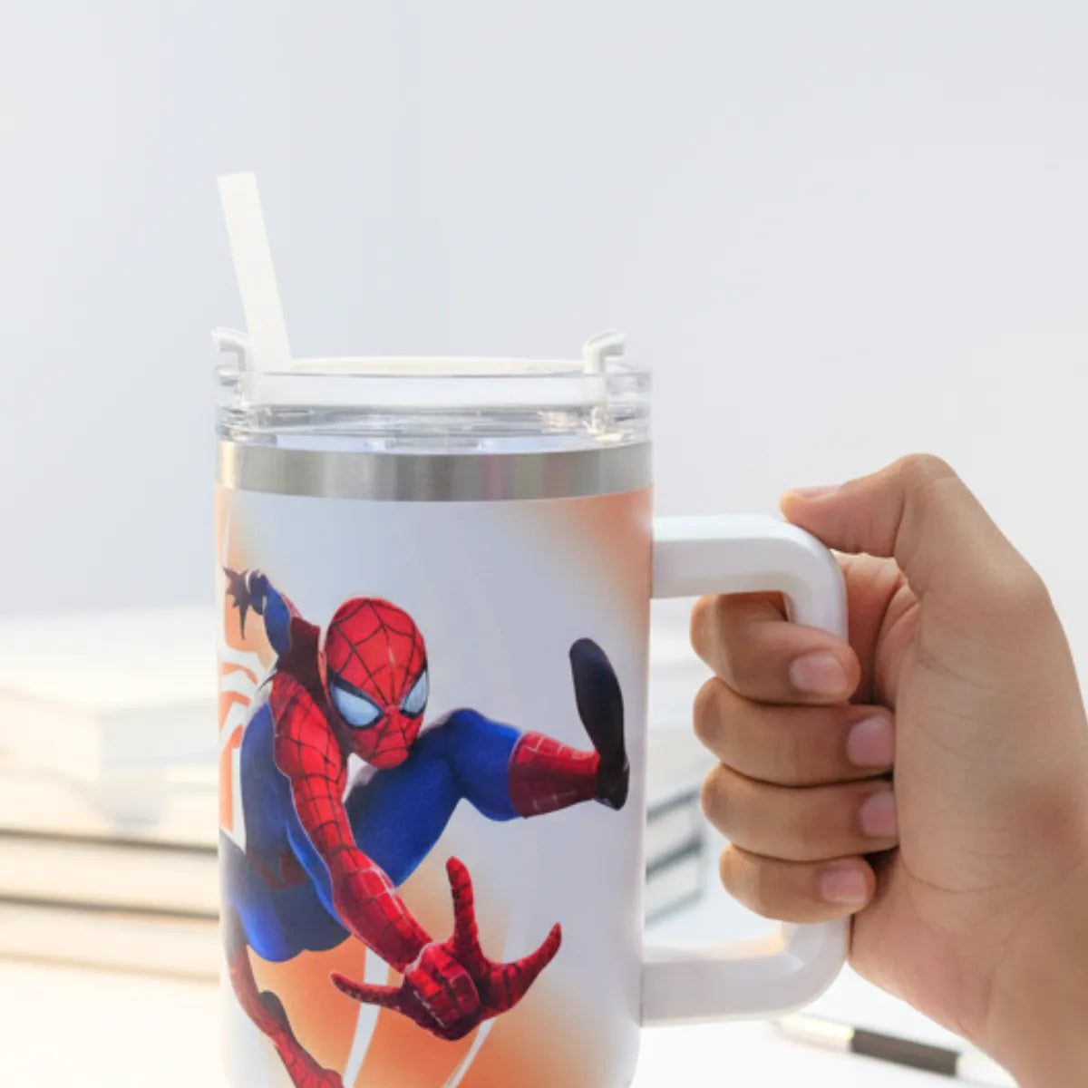 Hand Holding Stanley in Spiderman Design with Transparent Straw - Tinyminymo 