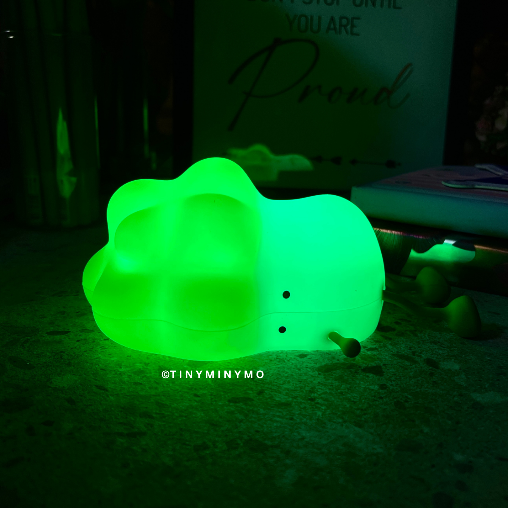 Glowing Cabbage Silicone Night Light on a Dark Surface with Green Lights On - Tinyminymo