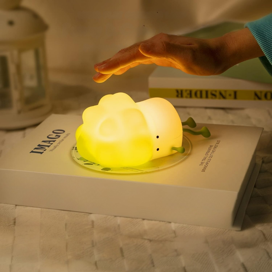 Cabbage Silicone Night Light Placed on a Book with a Hand Reaching Out to Tap it - Tinyminymo