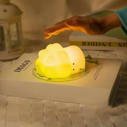 Cabbage Silicone Night Light Placed on a Book with a Hand Reaching Out to Tap it - Tinyminymo
