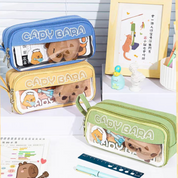 Three 'Capybara' themed pencil cases in different colors kept on a desk with other stationery items - Tinyminymo