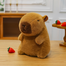 Load image into Gallery viewer, Capybara Plushie on a Wooden Surface with Strawberries - Tinyminymo

