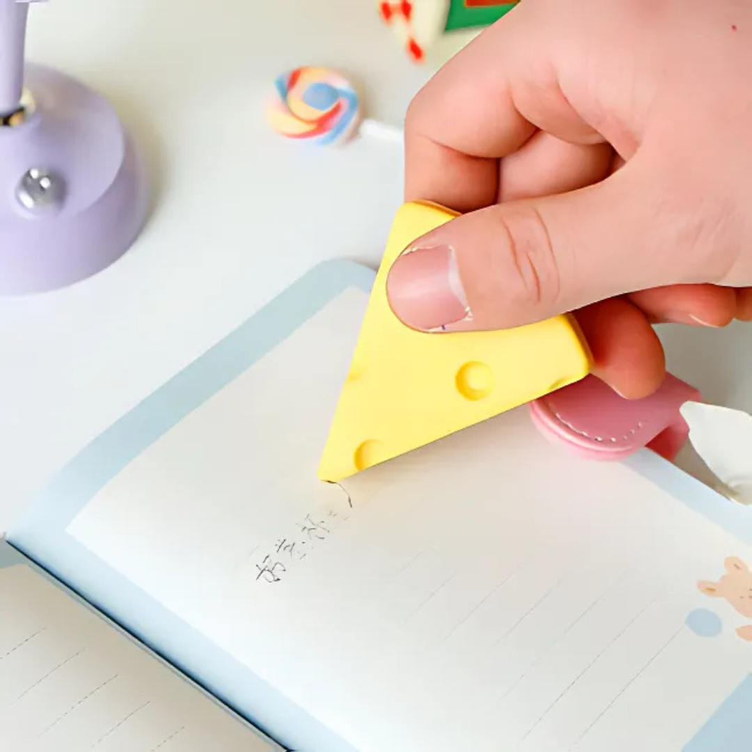 Hand Using a Yellow Cheese Eraser on a Notebook - Tinyminymo