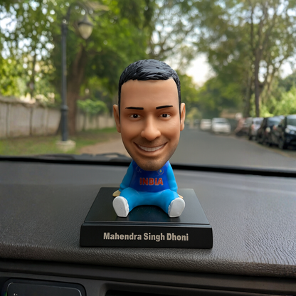 Bobblehead of Mahendra Singh Dhoni on a car dashboard - Tinyminymo