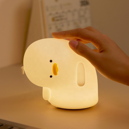 Crooked Neck Duck Silicone Night Light Placed on a Table and a Hand Touching it - Tinyminymo