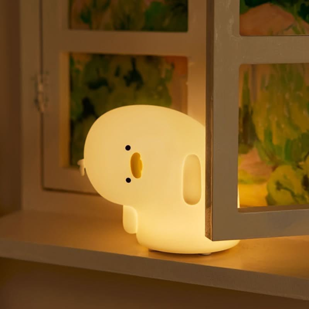 Crooked Neck Duck Silicone Lamp on Window Glowing in Warm Yellow Light with Beautiful Background - Tinyminymo