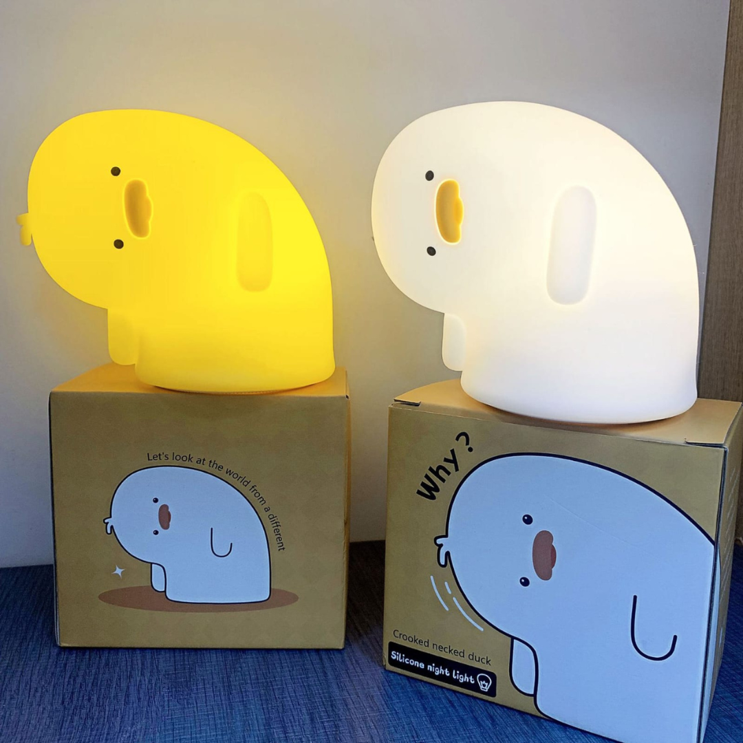 Two Crooked Neck Duck Silicone Night Lights Placed on Box, One Glowing White, the Other Emitting a Soft Yellow Light - Tinyminymo