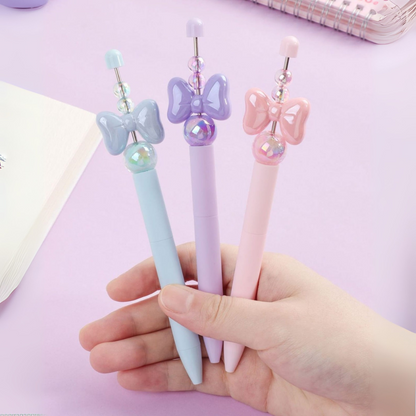 Three Decorative Crystal Bowknot Pen with Bow and Pearl Designs Helds in a Hand - Tinyminymo
