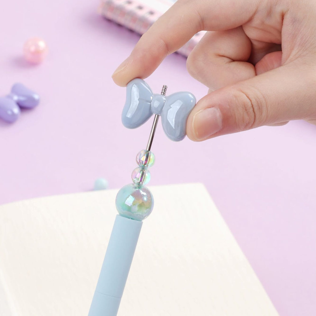Blue Crystal Bowknot Pen with Bow and Beads Held in a Hand - Tinyminymo