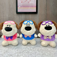 Three Cute Doggo Soft Toys Wearing Colorful Accessories, Sitting on a Textured Surface with a Framed Picture in the Background - Tinyminymo
