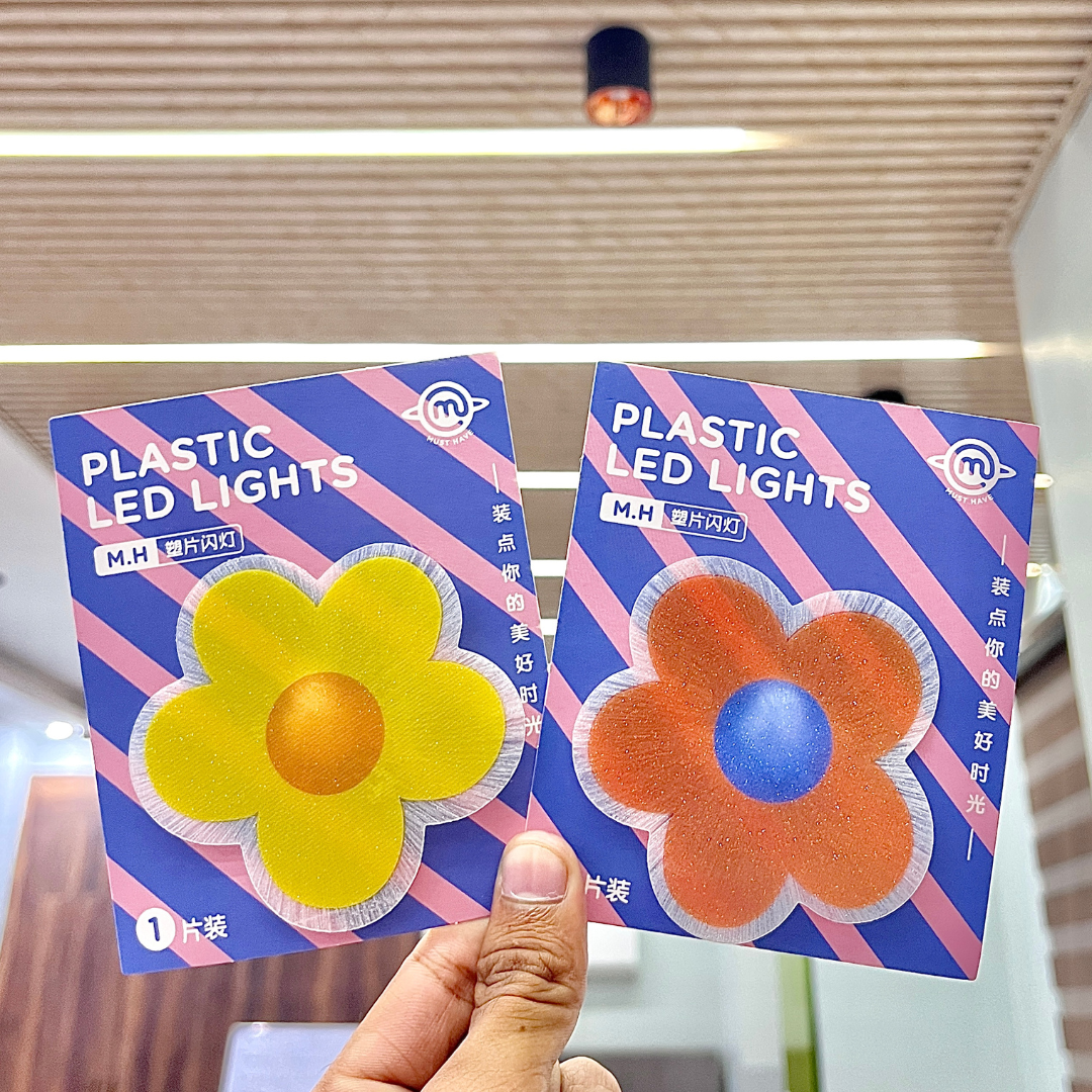 Two Pieces of Cute Flower Stick on Light held by a hand - Tinyminymo