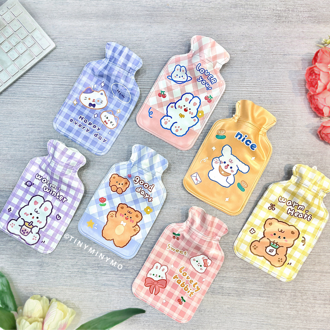 A set of colorful patterned, cartoon-themed Cute Hot Water Bags displayed on a Grey surface - Tinyminymo