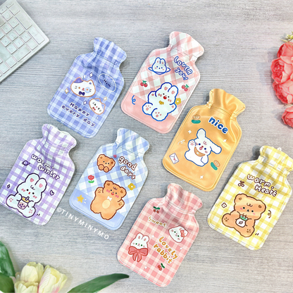A set of colorful patterned, cartoon-themed Cute Hot Water Bags displayed on a Grey surface - Tinyminymo