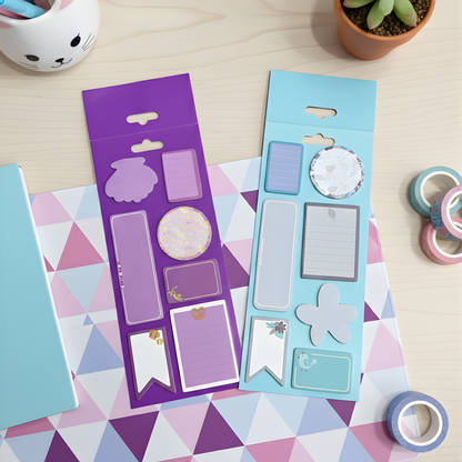 Two Colors of decorative stickers on a colorful geometric-patterned surface with tape and a plant in the background - Tinyminymo