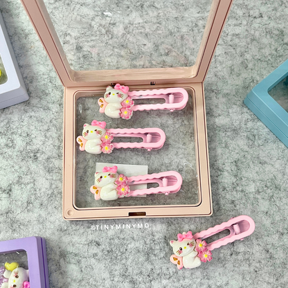 Cute Kitty Hair Clips Set in a Transparent Case Placed on a Textured Surface - Tinyminymo