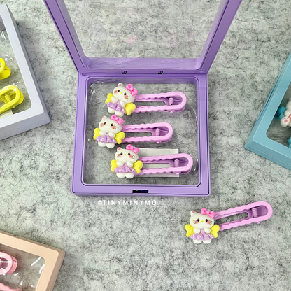 Cute Kitty Hair Clips Set in a Purple Case Placed on a Grey Surface - Tinyminymo