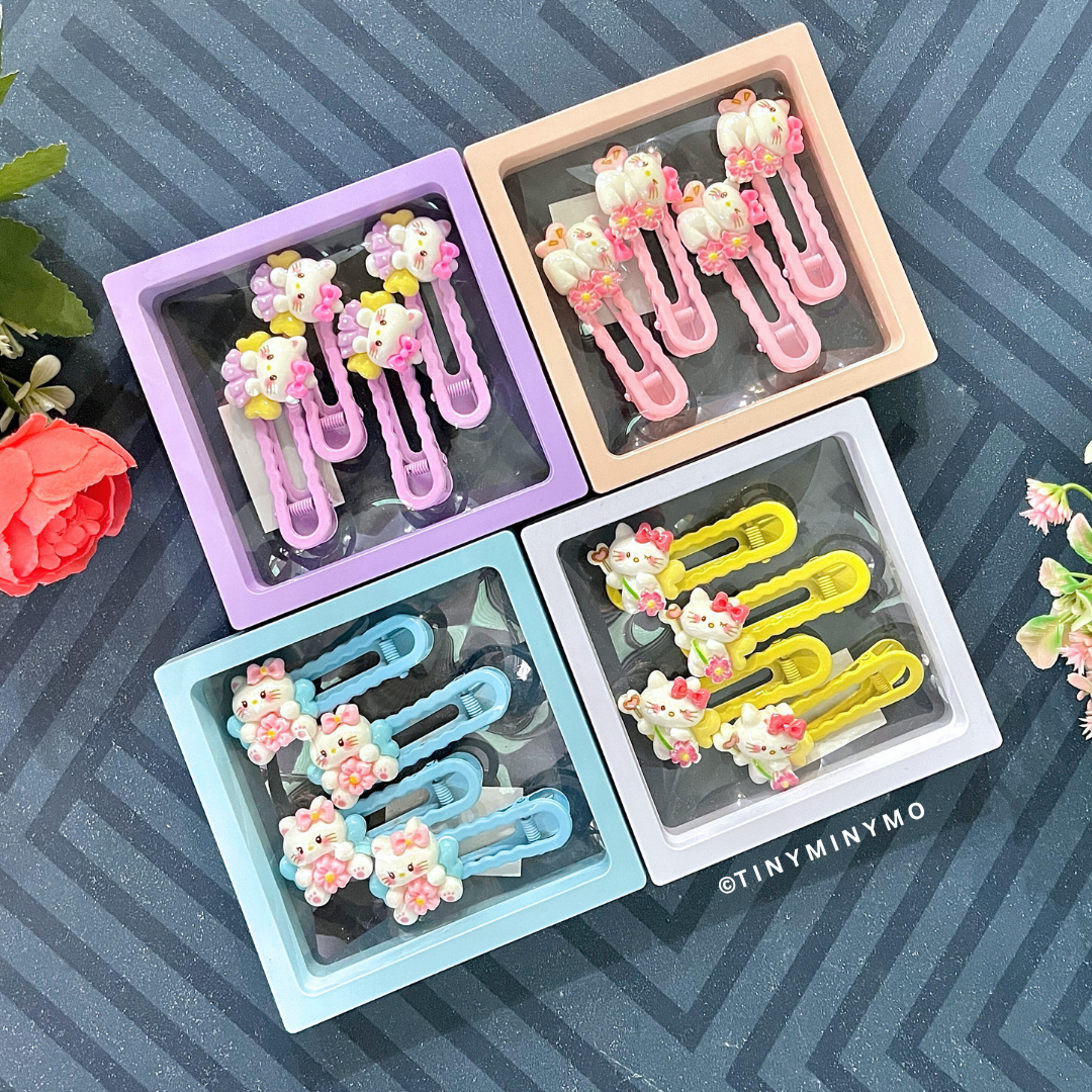 Colorful Cute Kitty Hair Clips in Clear Plastic Cases Placed on a Patterned Surface - Tinyminymo