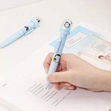 Load image into Gallery viewer, Penguin Design Pen Held by a Hand on a Book - Tinyminymo
