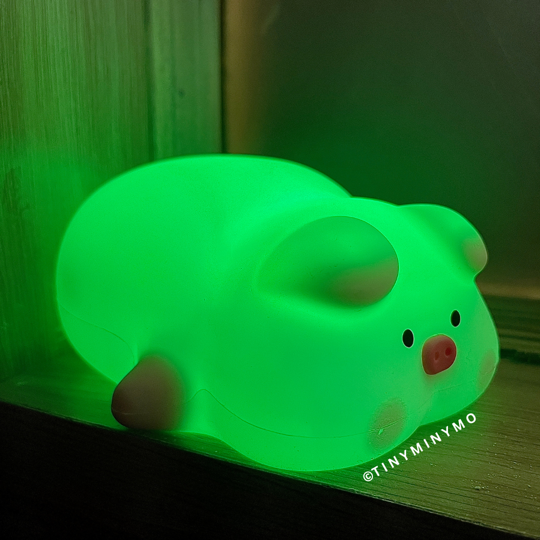 Pig Night Light in Green, on a Wooden Surface - Tinyminymo